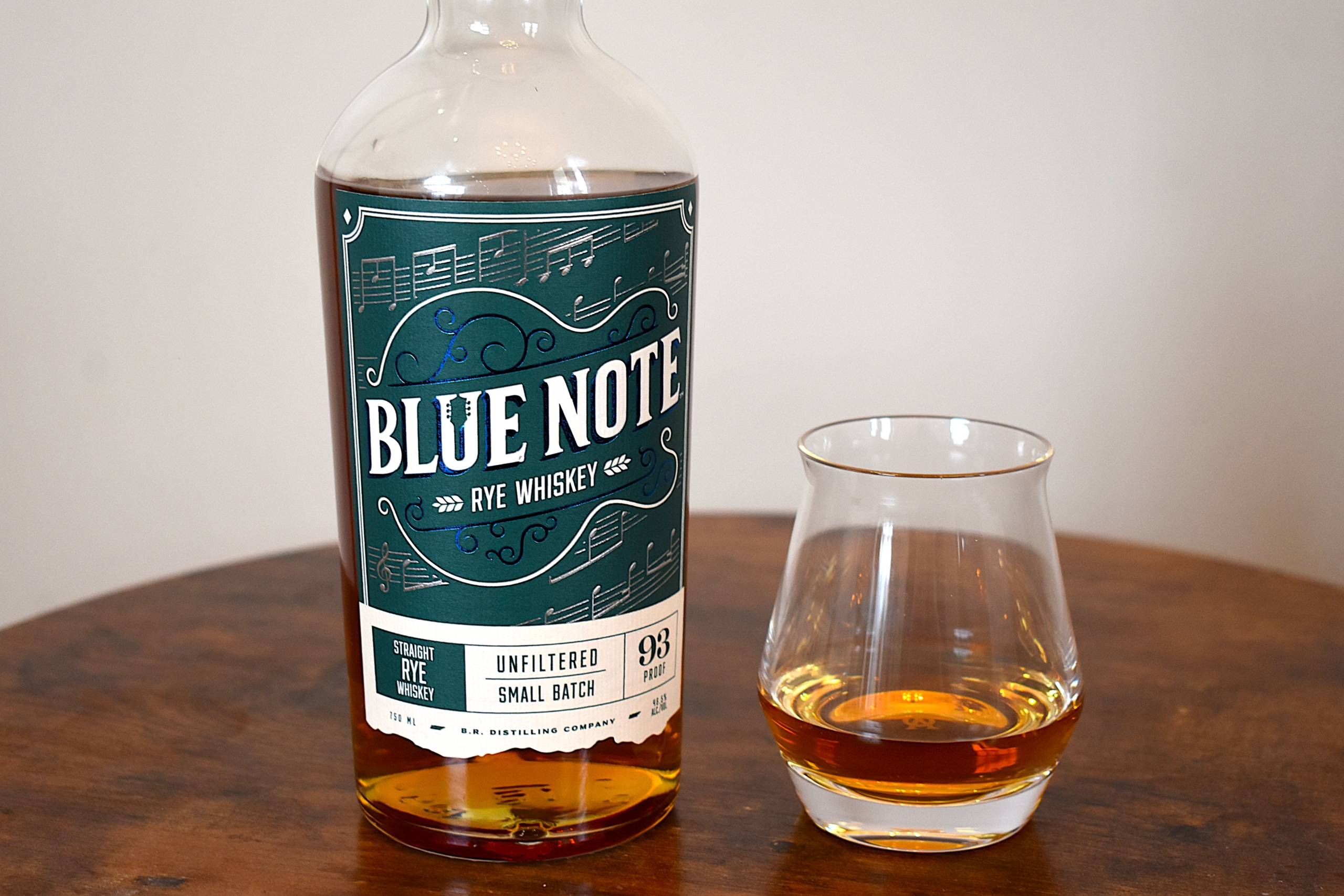 Blue Note Rye Whiskey Bottle and the whiskey poured into an Aged & Ore Neat Glass next to it