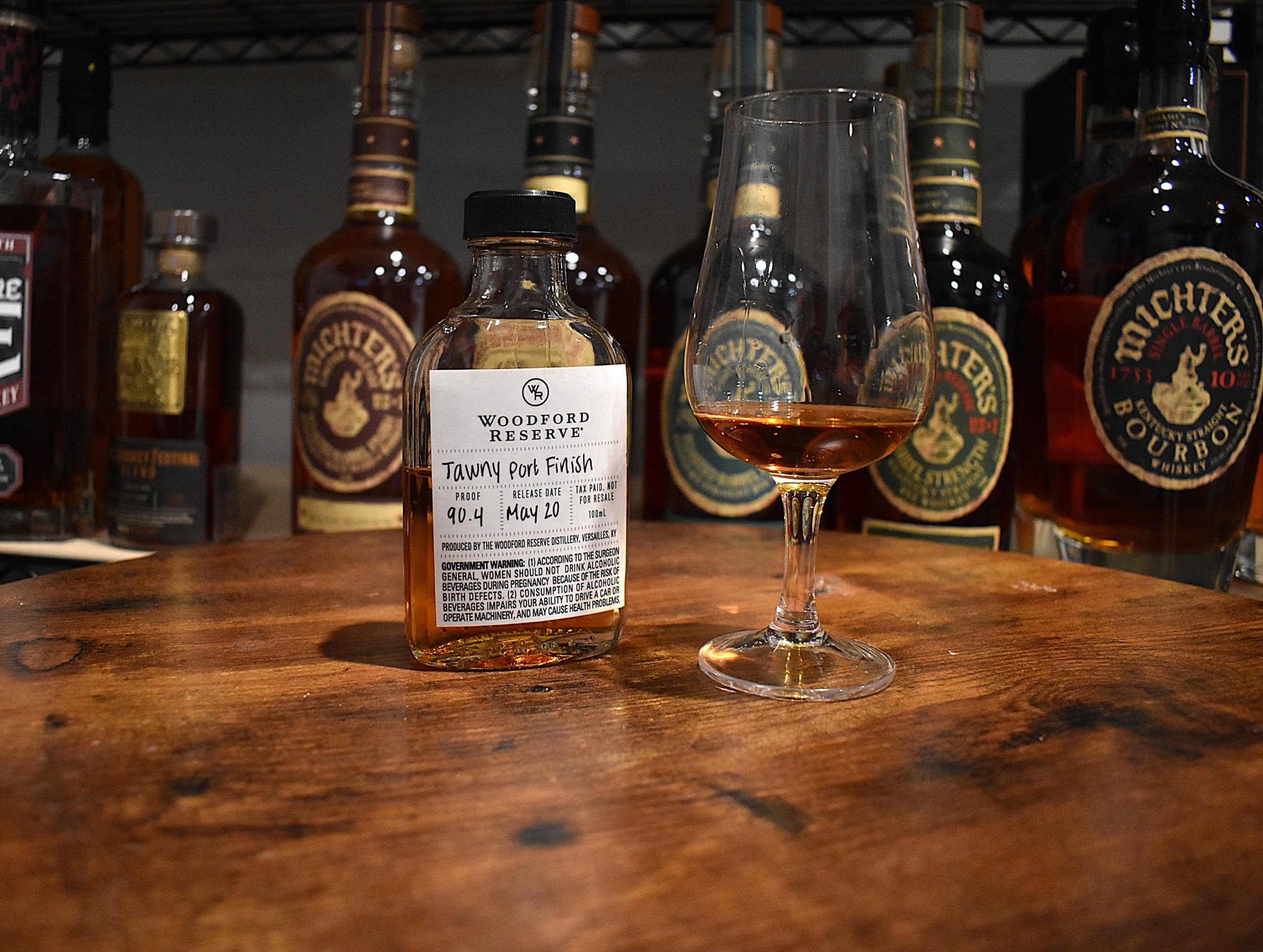 Woodford Reserve Distillery Series Tawny Port Finish Sample Bottle with copita nosing glass next to it with the bourbon in it