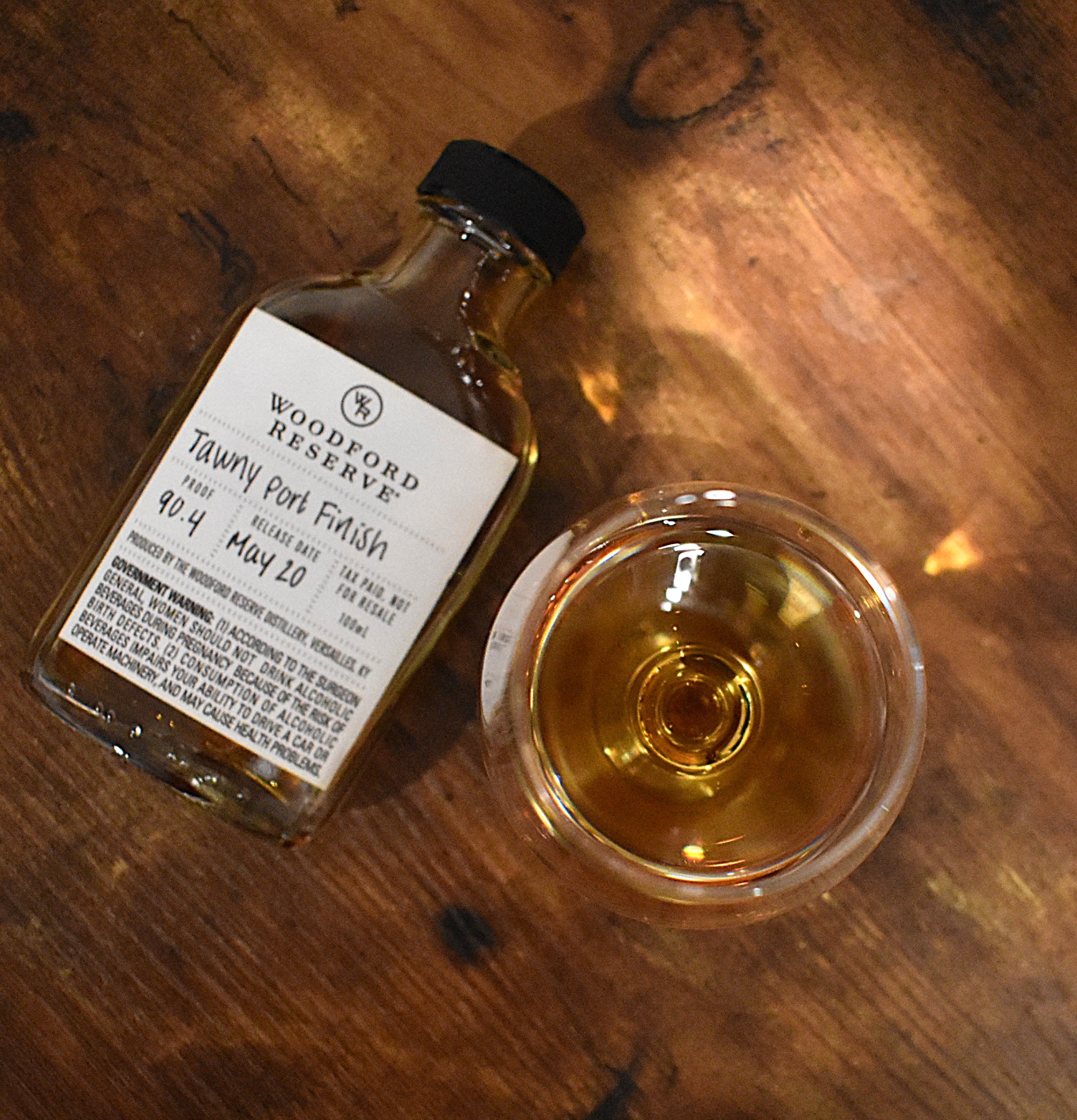 top down view of Woodford Reserve Distillery Series Tawny Port Finish Sample Bottle with copita nosing glass next to it with the bourbon in it